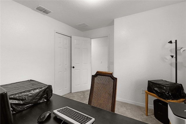 office area with light colored carpet and a textured ceiling