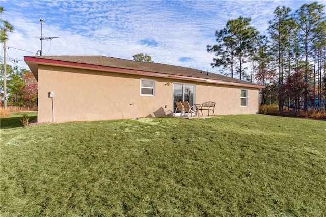 238 Oak Lane Cir, Ocala, FL 34472 - rear view of property featuring stucco siding and a lawn