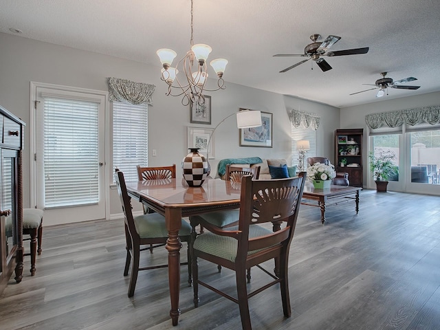 dining room featuring a textured ceiling, ceiling fan with notable chandelier, and hardwood / wood-style floors