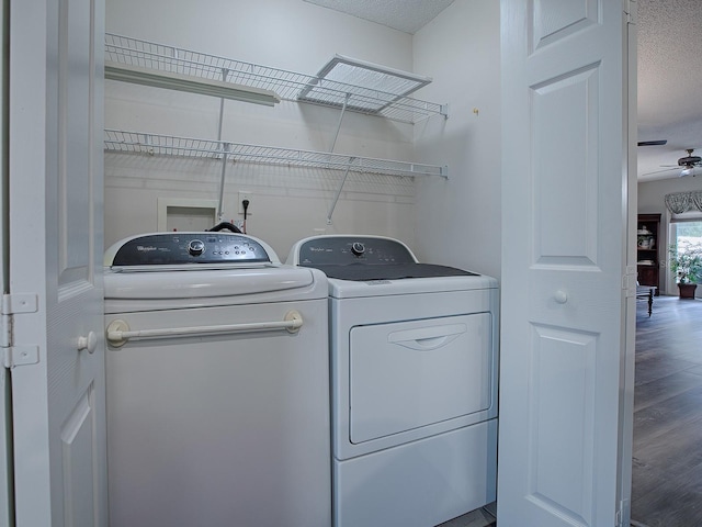 laundry area featuring a textured ceiling, ceiling fan, washer and dryer, and hardwood / wood-style floors