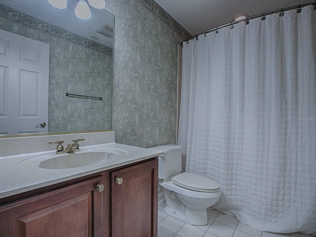 bathroom featuring a textured ceiling, toilet, tile patterned floors, and vanity