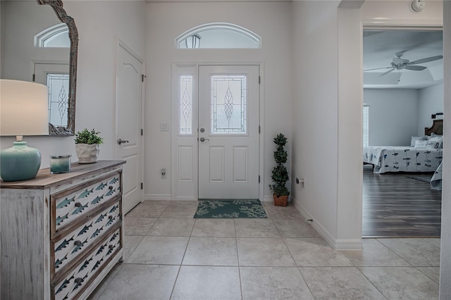 foyer with ceiling fan and light tile patterned floors