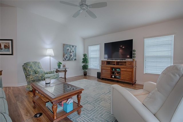 living room with ceiling fan, wood-type flooring, and lofted ceiling