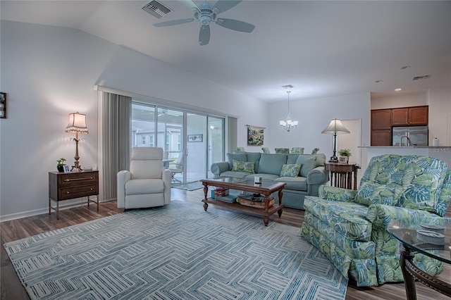 living room featuring ceiling fan with notable chandelier and wood-type flooring