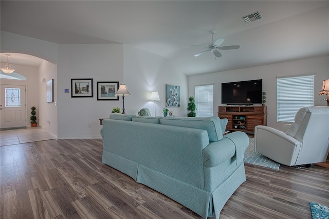 living room with dark wood-type flooring and ceiling fan