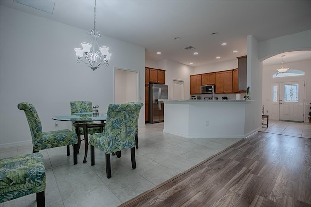 dining room featuring a notable chandelier and light hardwood / wood-style flooring