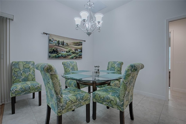 dining space featuring an inviting chandelier and light tile patterned floors