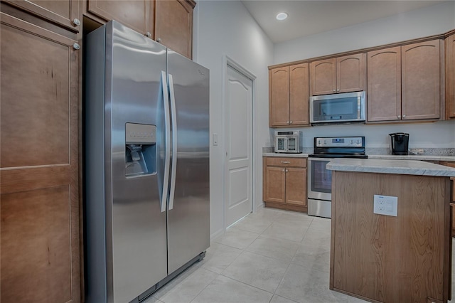 kitchen featuring light tile patterned floors and stainless steel appliances