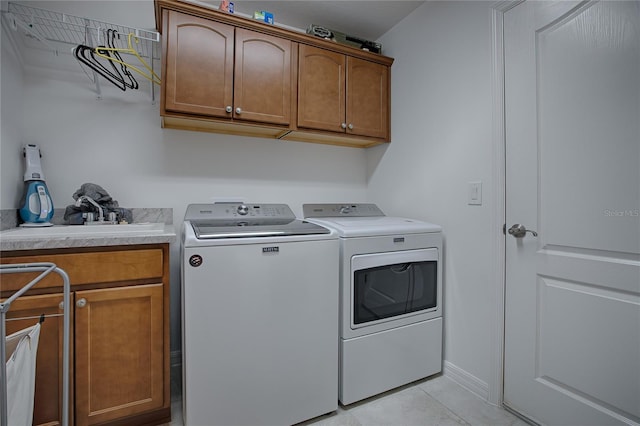 washroom featuring cabinets, separate washer and dryer, sink, and light tile patterned flooring