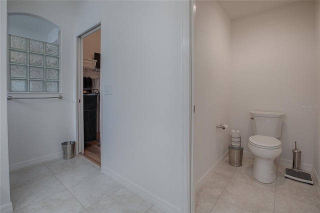 bathroom with toilet and tile patterned flooring