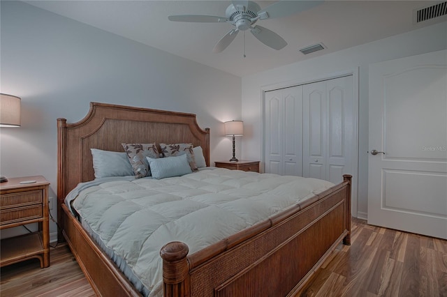 bedroom with a closet, hardwood / wood-style flooring, and ceiling fan