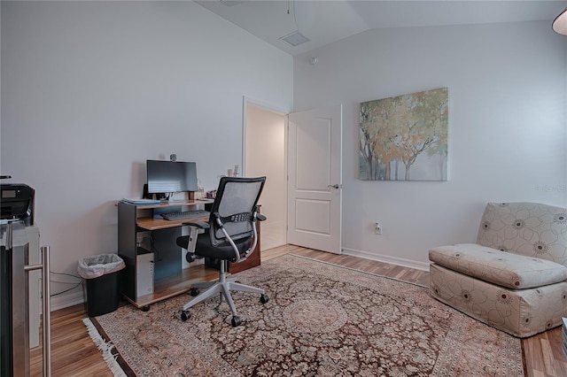 office featuring vaulted ceiling and light hardwood / wood-style floors