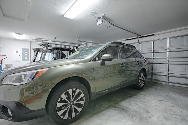 garage featuring a garage door opener and electric panel