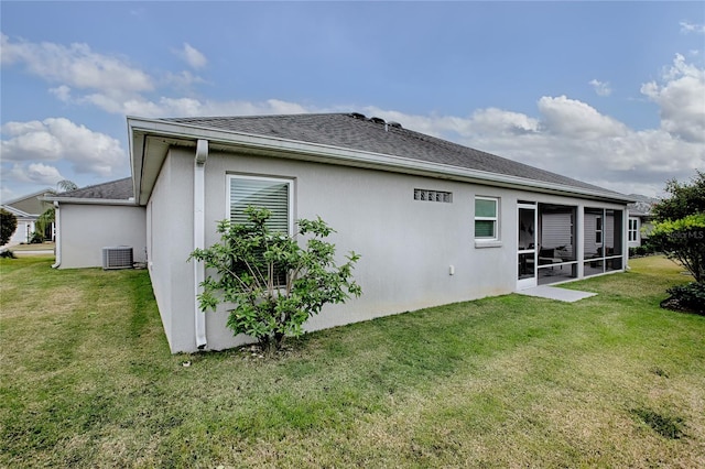 back of property with cooling unit and a lawn