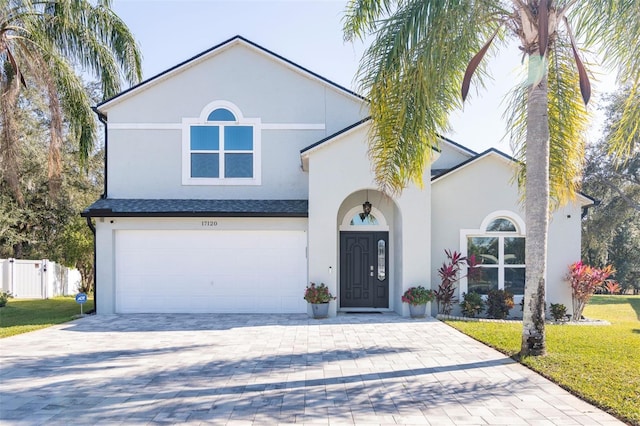 view of front facade featuring a garage and a front lawn