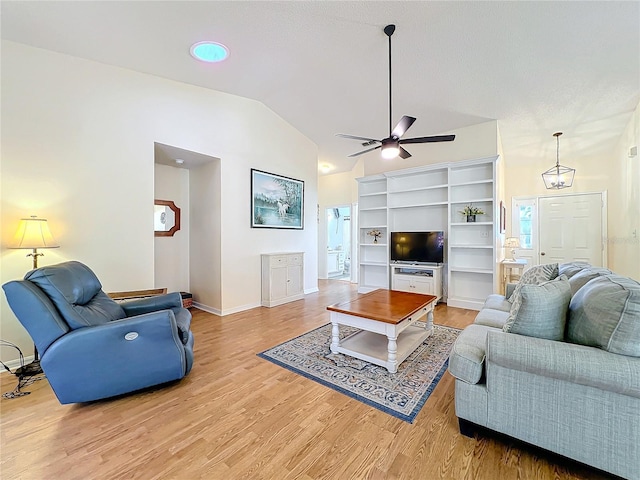 living room with ceiling fan, vaulted ceiling, and light hardwood / wood-style flooring