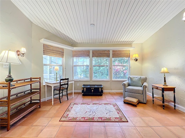 living area featuring tile patterned flooring and wood ceiling