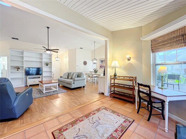 living room featuring tile patterned floors and ceiling fan