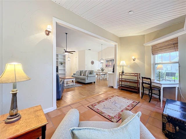 living room with ceiling fan and tile patterned floors