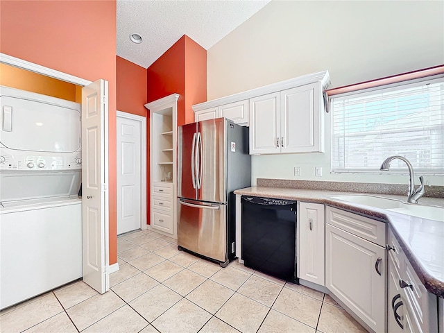 kitchen with stainless steel refrigerator, white cabinets, black dishwasher, and sink