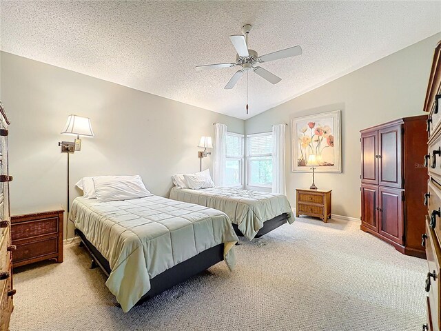 carpeted bedroom featuring lofted ceiling, a textured ceiling, and ceiling fan