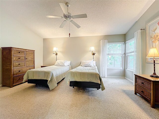 carpeted bedroom featuring a textured ceiling and ceiling fan