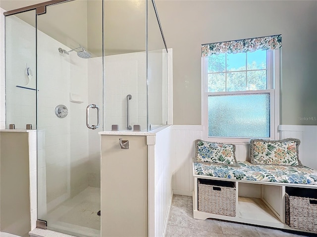 bathroom with a shower with shower door and tile patterned floors