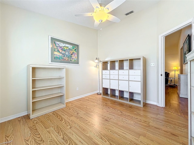 unfurnished bedroom with ceiling fan and light hardwood / wood-style floors