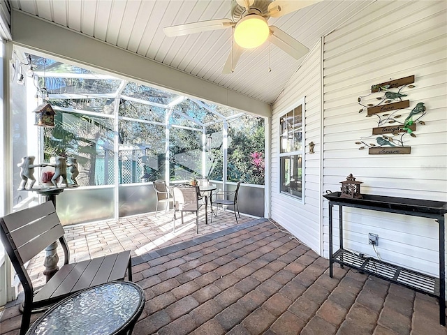 sunroom featuring ceiling fan and lofted ceiling