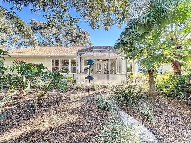 back of property with a lanai