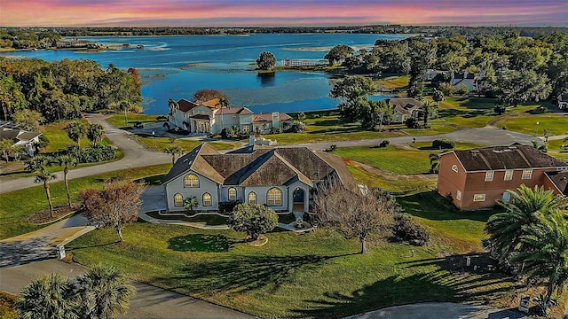 aerial view at dusk with a water view