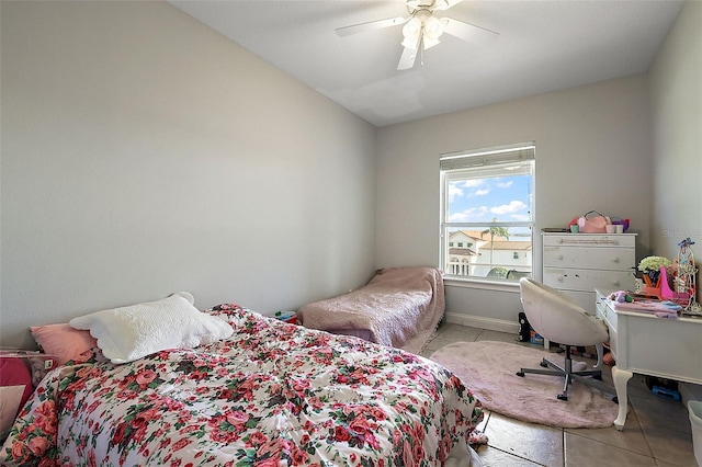 bedroom with ceiling fan and light tile patterned floors