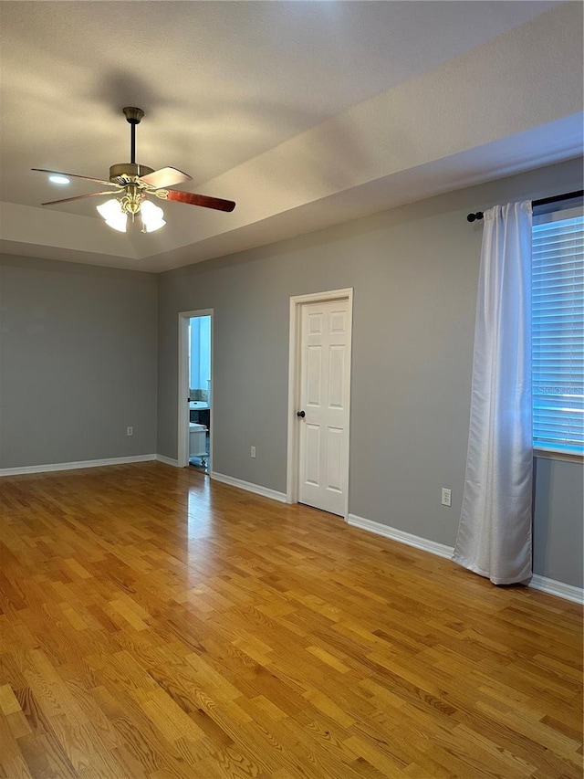 empty room featuring light wood-type flooring and ceiling fan