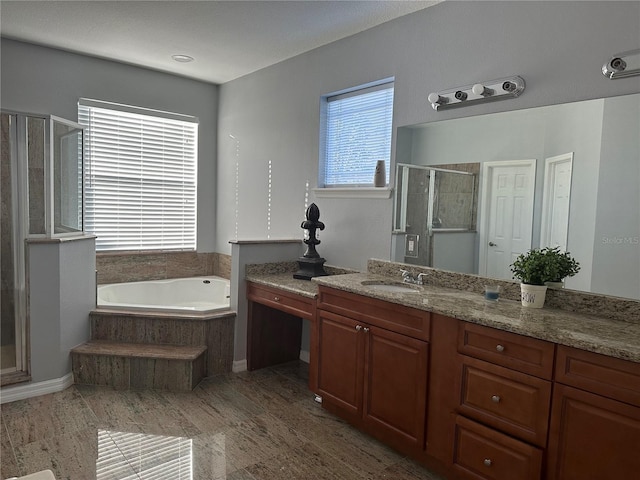 bathroom featuring vanity and independent shower and bath