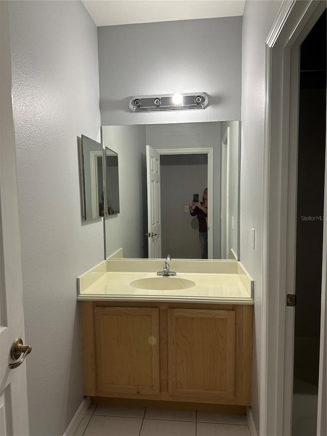 bathroom with tile patterned flooring and vanity