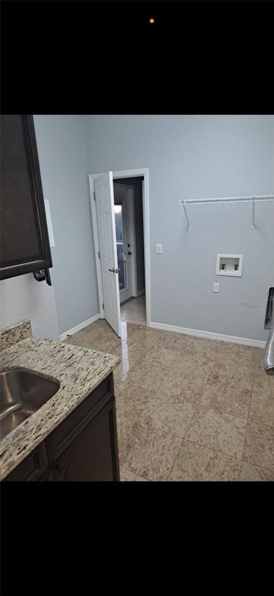 laundry room with sink, cabinets, and hookup for a washing machine