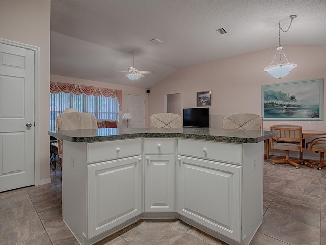 kitchen featuring a textured ceiling, white cabinets, lofted ceiling, decorative light fixtures, and ceiling fan