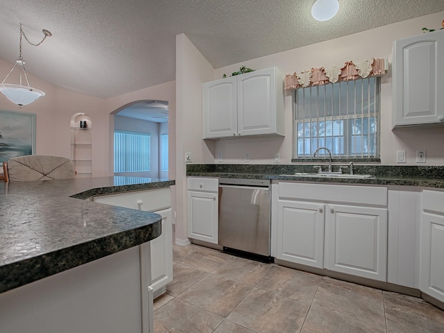 kitchen with decorative light fixtures, a textured ceiling, stainless steel dishwasher, white cabinets, and sink