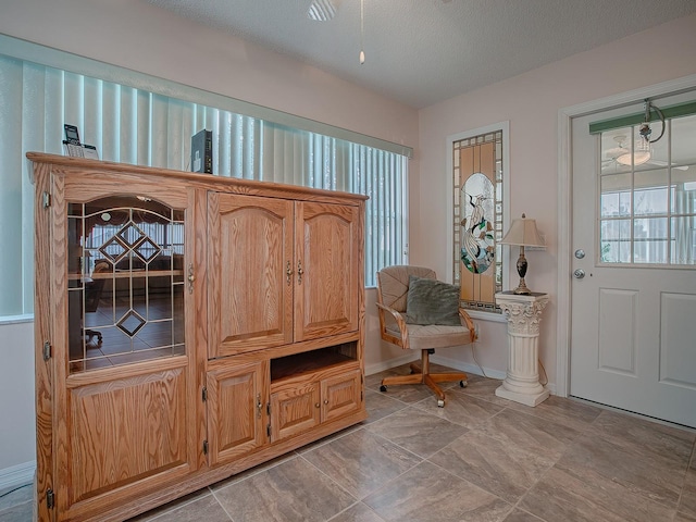 foyer entrance featuring a textured ceiling