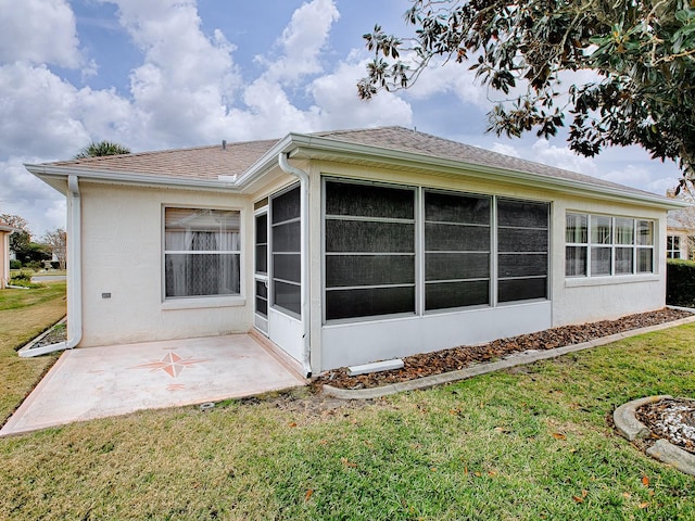 rear view of house featuring a yard and a patio