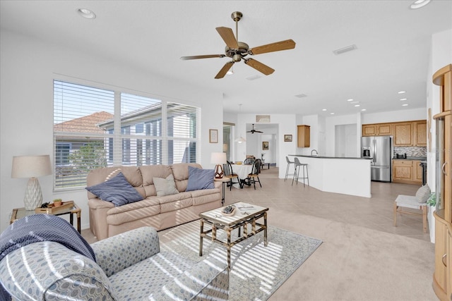 living room featuring ceiling fan and light carpet