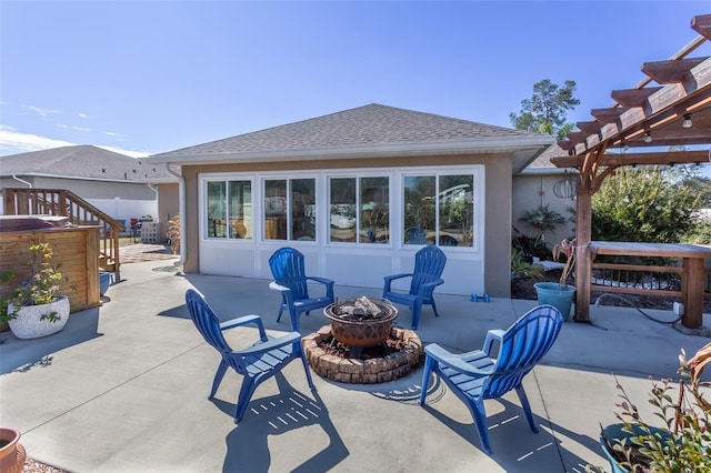 view of patio / terrace with a pergola and an outdoor fire pit