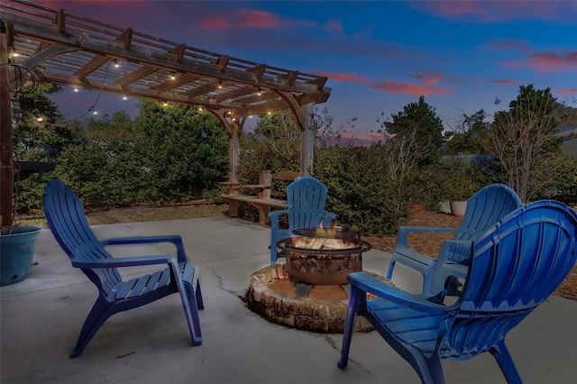 patio terrace at dusk featuring a pergola