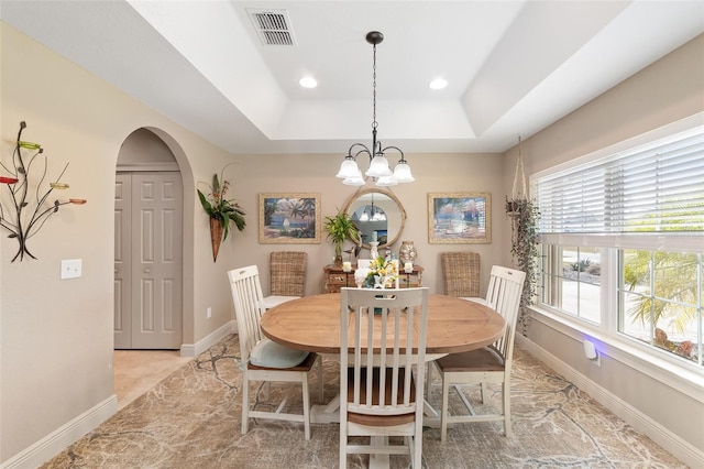 dining room featuring a raised ceiling