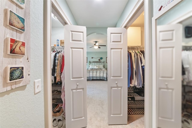 interior space featuring light carpet and ceiling fan