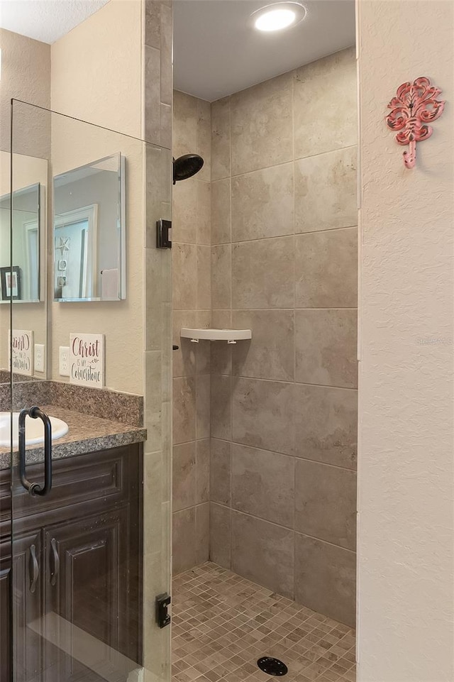 bathroom with vanity and a shower with door