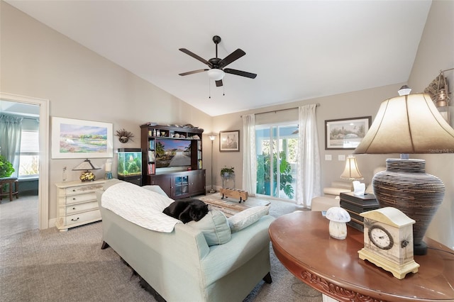 carpeted living room featuring vaulted ceiling and ceiling fan