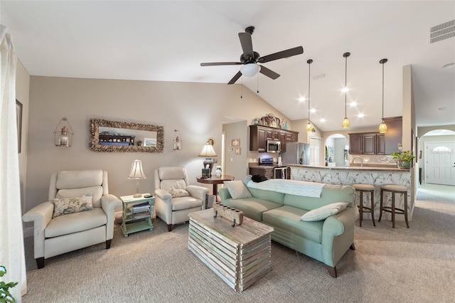 living room with ceiling fan, light colored carpet, high vaulted ceiling, and sink