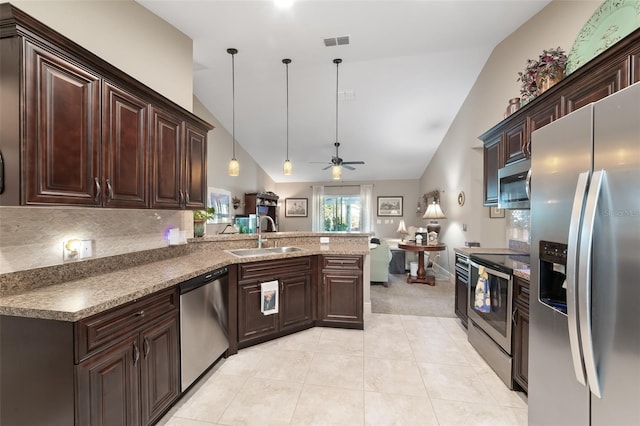 kitchen featuring sink, vaulted ceiling, kitchen peninsula, pendant lighting, and stainless steel appliances