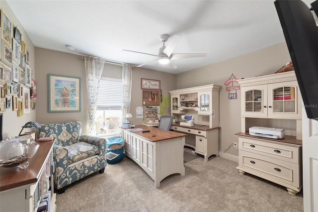 carpeted office featuring ceiling fan